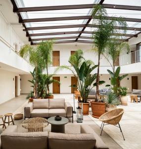 a living room with couches and plants at Hotel Porfirio Picota - Adults Recommended in Zahara de los Atunes +37 photos