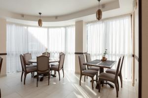 a dining room with a table and chairs at Carparosa Hotel in Bukovel