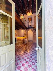 an open door to a room with a tile floor at O'scià Loft in Noto