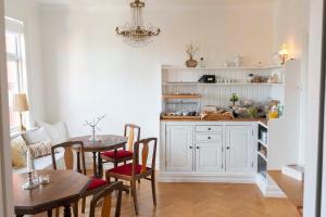a kitchen with a table and a dining room at Prästgårdens Pensionat in Mollösund +34 photos