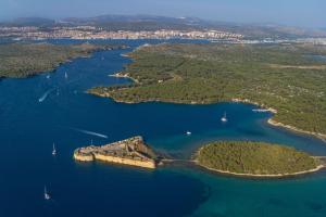 an island in the middle of a body of water at Apartment in Zlarin with balcony, W-LAN, washing machine (3813-2) in Zlarin