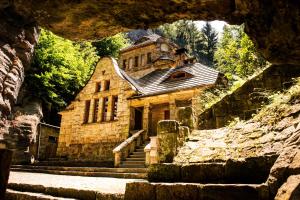 an old stone building with stairs in front of it at Stara Plynarna in Hřensko