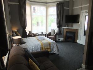 a living room with a bed and a couch at Dewsbury House in Blackpool