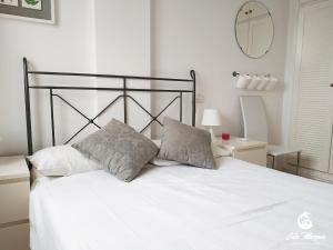 a white bed with two pillows on top of it at Cala Marqués Beach House in Vera