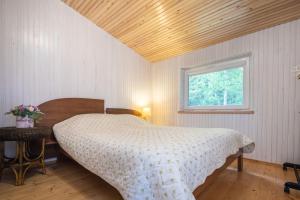 a bedroom with a bed and a window at Nameliai pas Jolita in Palanga