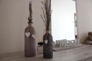 zwei Vasen mit Herzen auf dem Tisch in der Unterkunft Bachmeier's Gasthaus Traube Niederfell in Niederfell