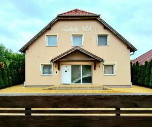 a house with a sign that reads jerky hall at Székely Ház in Sopron