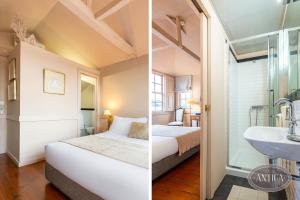 a hotel room with a white bed and white walls at Casa Antiga in Porto