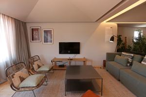 a living room with a couch and a table at Prime Riverside Duplex in Porto