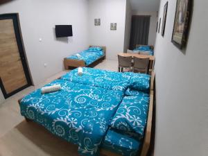 a bedroom with a bed and a table and chairs at Goka apartments in Gevgelija