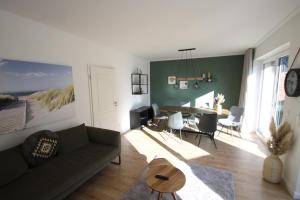 a living room with a couch and a table at 3100 - Kuhns Strandhus Grömitz in Grömitz