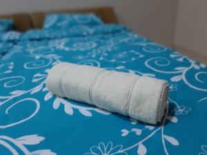 a roll of toilet paper sitting on top of a bed at Goka apartments in Gevgelija