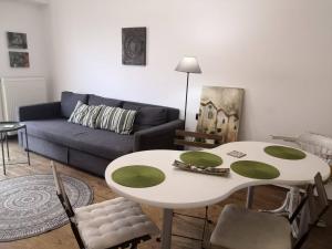 a living room with a table and a couch at City Square Apartment in Chania