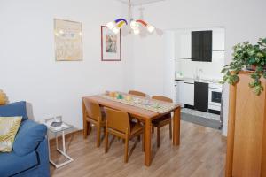 a living room with a dining room table and a blue couch at Appartamento Piera Rossa in Venice