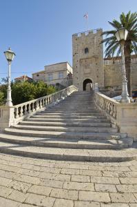 a stone staircase leading to a building with a castle at Ferienhaus SIKLUH-128-4 in Lumbarda