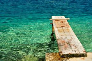 a wooden dock sticking out of the water at Ferienhaus SIKLUH-128-4 in Lumbarda
