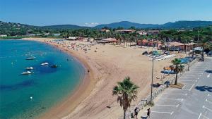 a beach with people and boats in the water at MarinesAppartement, La marina tropézienne 100m plage wifi fibre in Cogolin