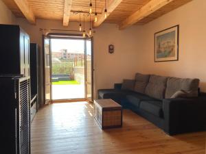 a living room with a couch and a tv at La bicicleta del Moncayo in Alcalá de Moncayo