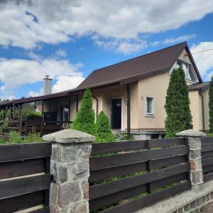 a house with a fence in front of it at Dom w (Między) lesie in Zwierzewo +46 photos