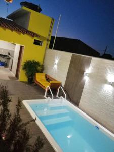 a swimming pool in front of a house at CASA TEMPORADA BARREIRINHAS 2 Quartos in Barreirinhas