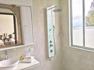 a bathroom with a sink and a mirror at Santelmo Casa Hotel Boutique in Paipa