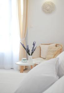 a bedroom with a bed and a table and a chair at Apanema Paros in Naousa