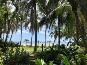 a view of the beach from a plantation of palm trees at Rimtalay Home Huahin in Hua Hin