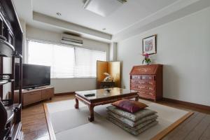 a living room with a coffee table and a tv at KB1*Unique HUGE house for family /JR +subway in Osaka