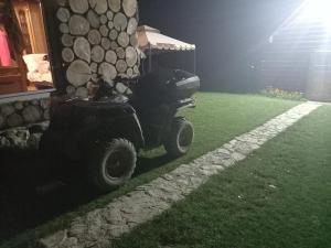 a golf cart parked next to a house at night at Eco Resort Nad Karpatamy in Hrobyshche