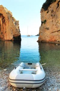 a boat sitting on the shore of a body of water at Holiday Home (139-2) in Vis
