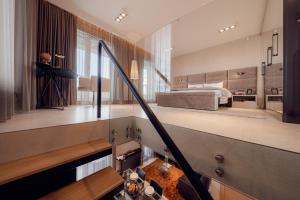 a large bedroom with a bed and a staircase at ONE Luxury Apartments in Rzeszów