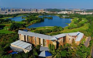 an aerial view of a building with a lake at Shenzhen Castle Hotel in Longgang