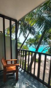a bench on a balcony with a view of the beach at Thundi Sea View in Fulidhoo