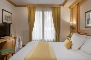 Posteľ alebo postele v izbe v ubytovaní Hotel Cristallo