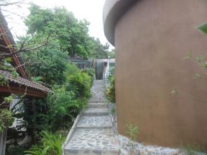 a stairway leading up to a building with plants at High Life Bungalow in Haad Yao