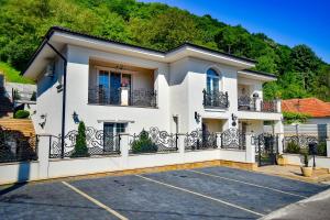 a white house with a balcony at SaraDa Boutique Luxury Apartment in Deva