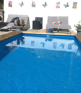 a swimming pool with blue water in a house at Casa di Emma in Santo-Pietro-di-Tenda