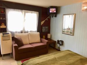 a living room with a couch and a television at Casa SERGIO Budva Rooms & Apartments in Budva