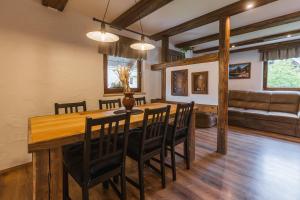 uma sala de jantar com uma mesa de madeira e cadeiras em Apartment Trentar em Kranjska Gora