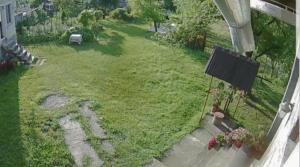 a woman sitting on a bench in a yard at Pensiunea Adeluta Apartament in Călimăneşti