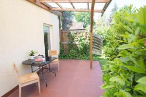 a patio with a table and chairs and a pergola at FeWo Engler Lüneburg Hopfengarten in Lüneburg