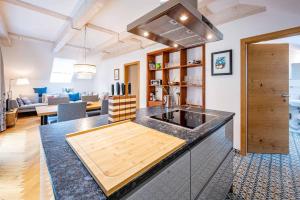 a kitchen with a counter top and a living room at Forsthaus Heilsberg in Wiesent