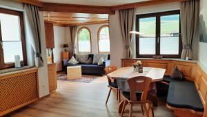 a living room with a table and chairs and a couch at Appartements Haus Olympia in Innsbruck