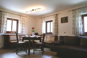 a living room with a table and chairs and a couch at Vorderhof in Sankt Martin am Tennengebirge +43 photos