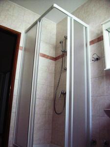 a shower with a glass door in a bathroom at House Vranjica (608) in Seget Vranjica