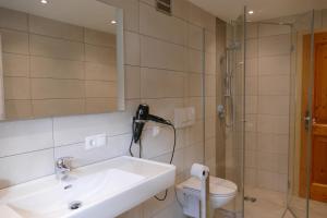 a bathroom with a sink and a shower at Vorderhof in Sankt Martin am Tennengebirge