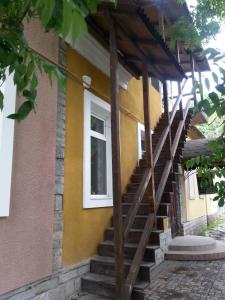 a building with stairs leading up to a window at Мини-гостиница in Kamianets-Podilskyi