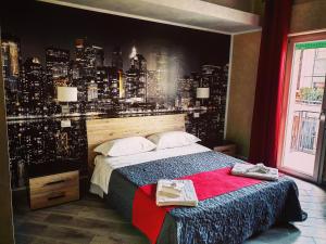 a bedroom with a large bed with a city backdrop at Central Campobasso in Campobasso