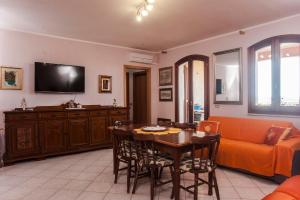 a living room with a table and a couch at Casa Elena in Masainas