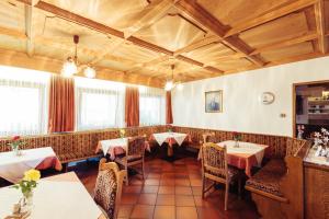 a restaurant with tables and chairs in a room at Ferienwohnung Pension Stern in Aldino +7 photos